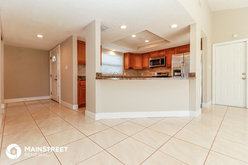 the kitchen is open to the dining room and living room