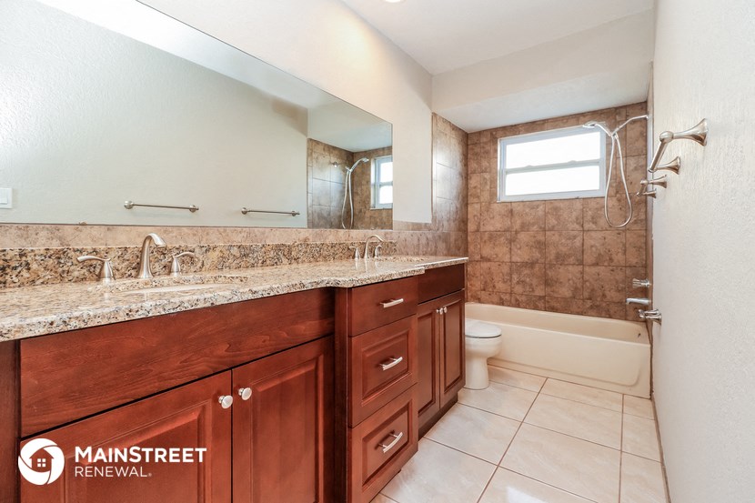 a bathroom with a sink and a toilet and a shower