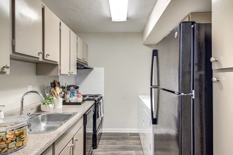 a kitchen with stainless steel appliances and white cabinets