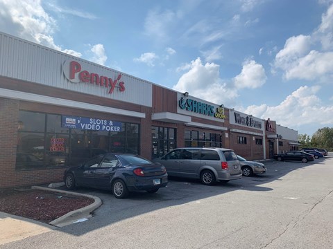 A Penny's store with a car parked in front.