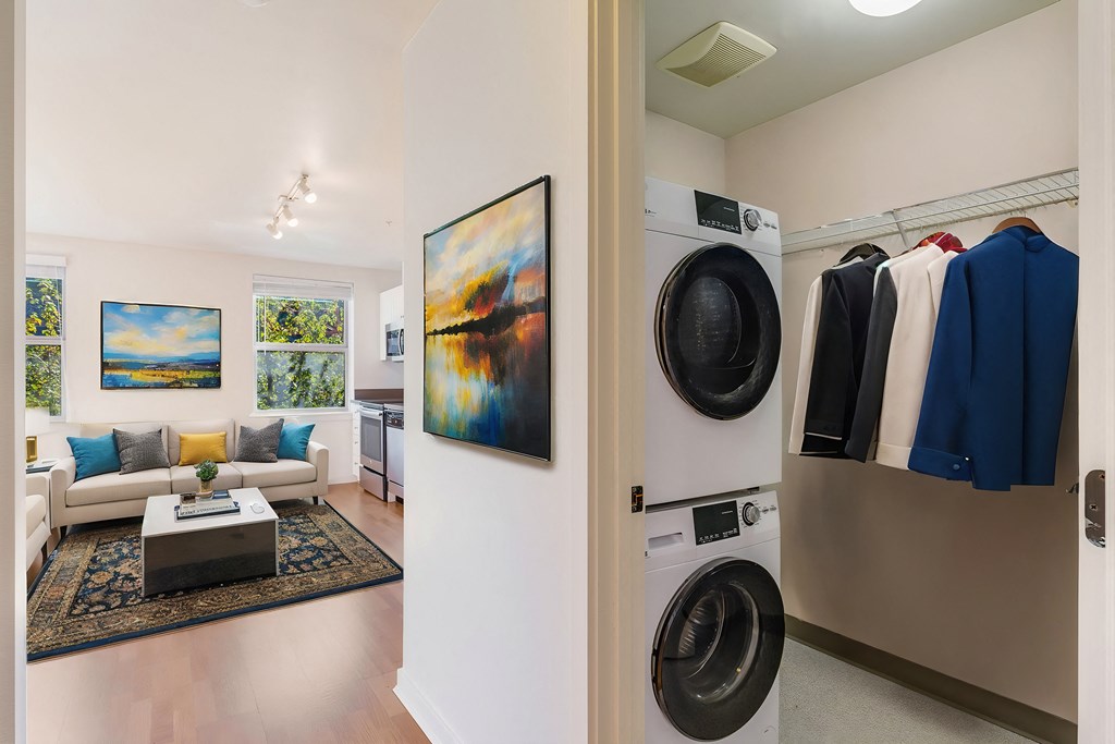 a living room with a washing machine and a washer and dryer