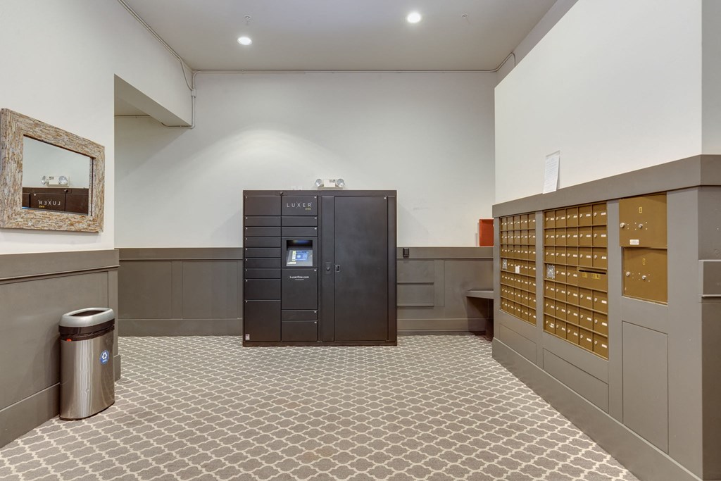 the lobby of a building with lockers and a vending machine