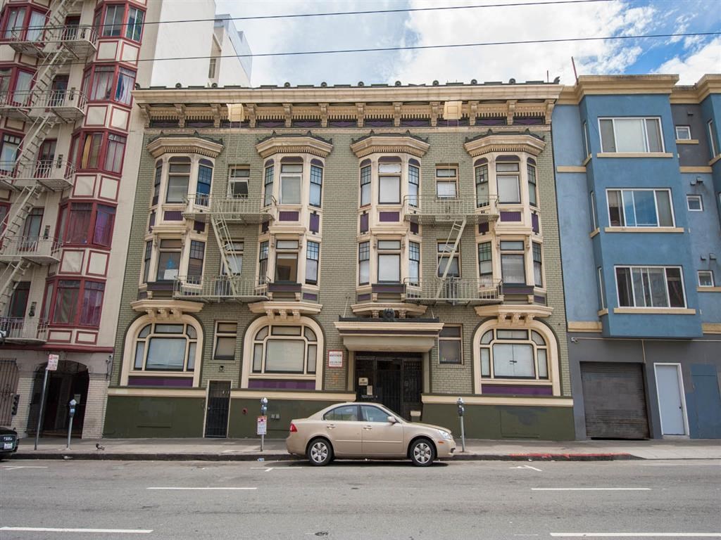 a car parked in front of a building on a street