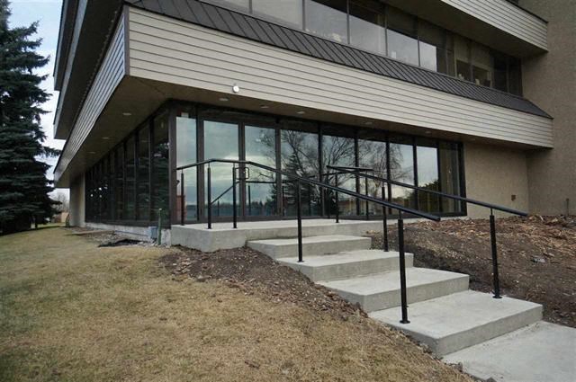 a building with a staircase and glass windows