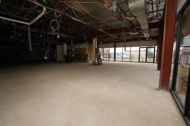 an empty room with a ladder in the middle of it