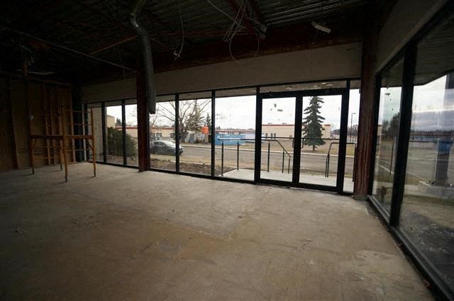 an empty room in a building with glass doors
