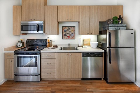 a kitchen with stainless steel appliances and wooden cabinets
