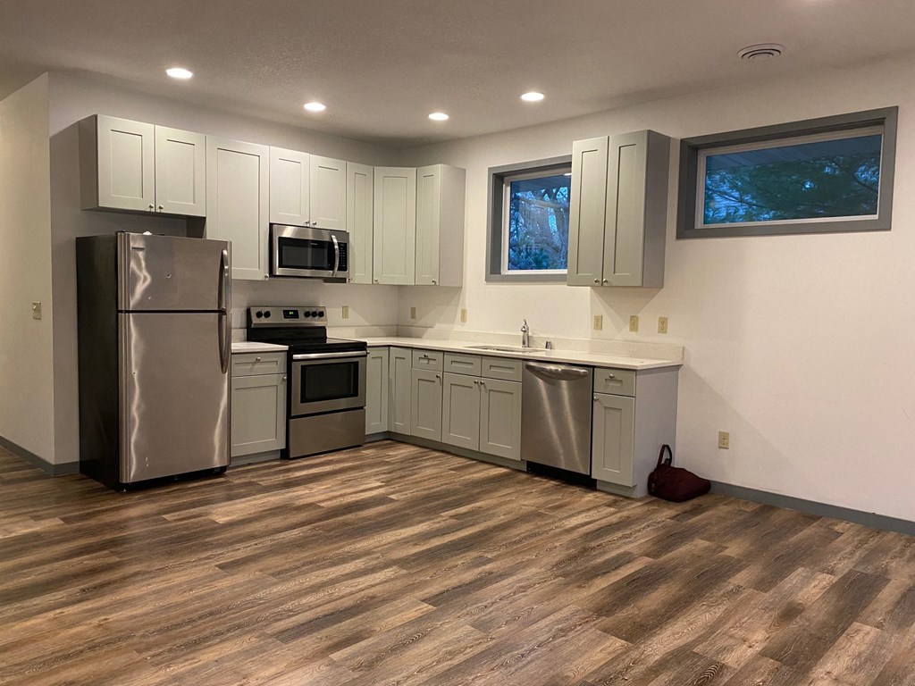 a kitchen with stainless steel appliances and white cabinets