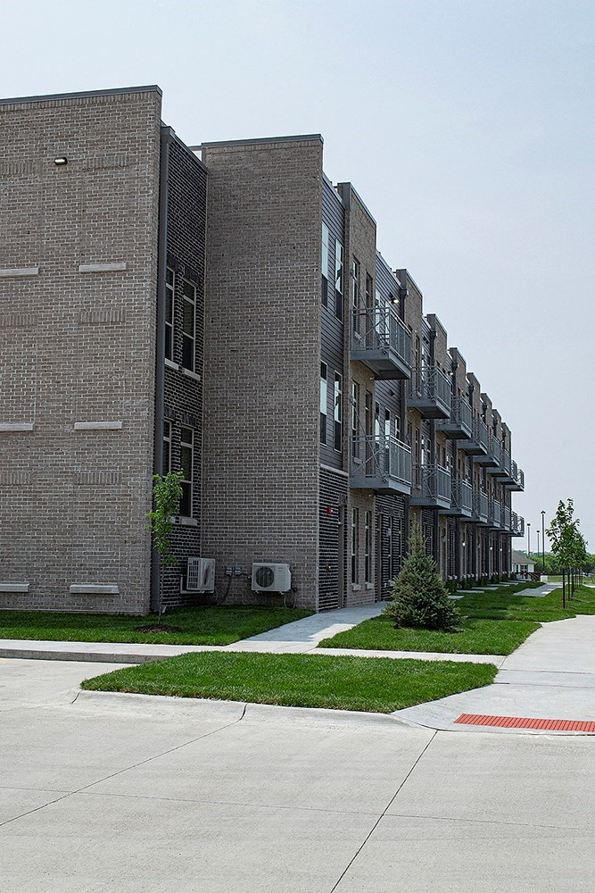 a large brick building with a sidewalk in front of it
