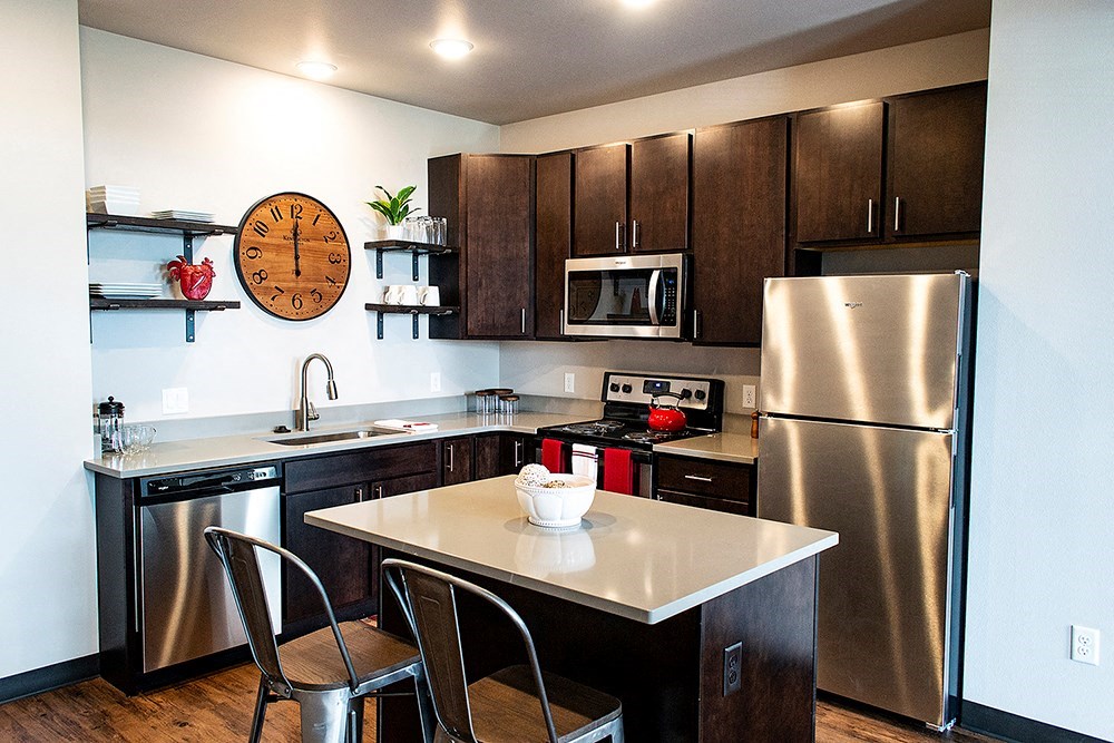 a kitchen with stainless steel appliances and a counter top