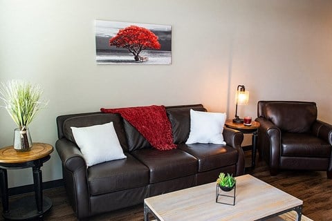 a living room with a leather couch and a coffee table