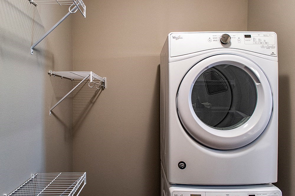 a washer and dryer in a laundry room next to a closet