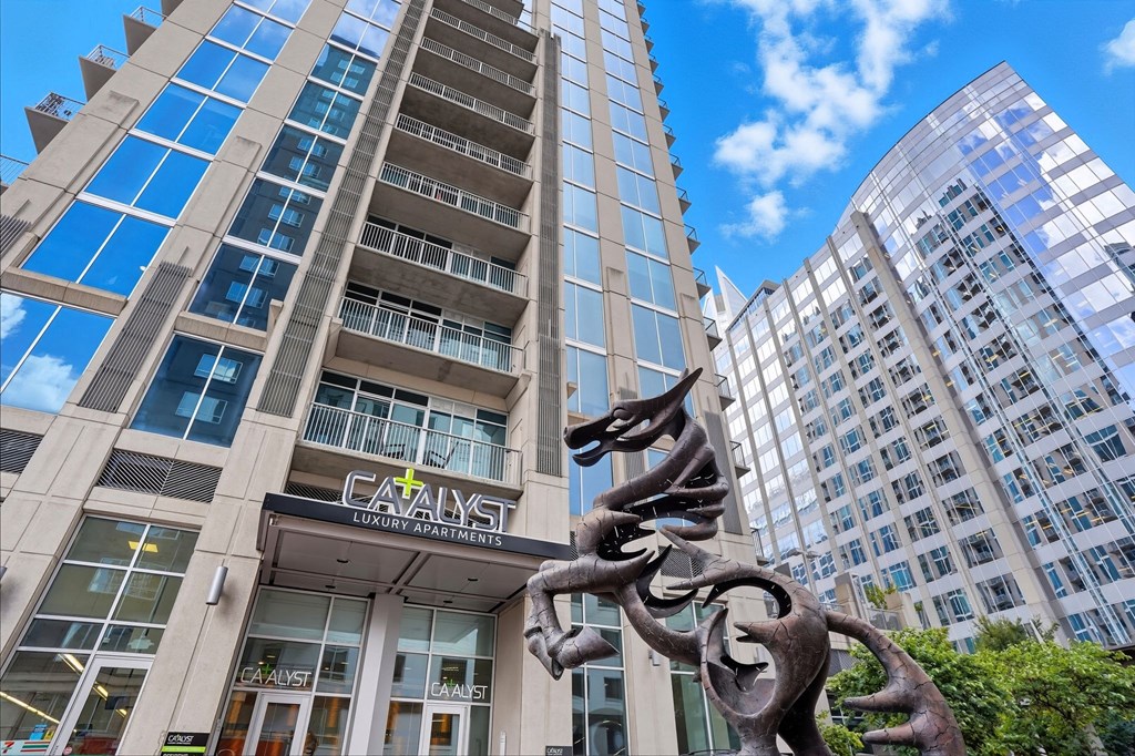 A tall building with the word "CALYST" on it.