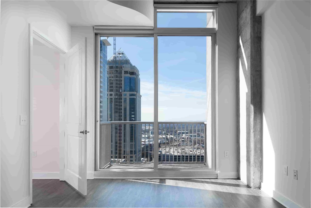 A modern room with a view of a cityscape through a large window.