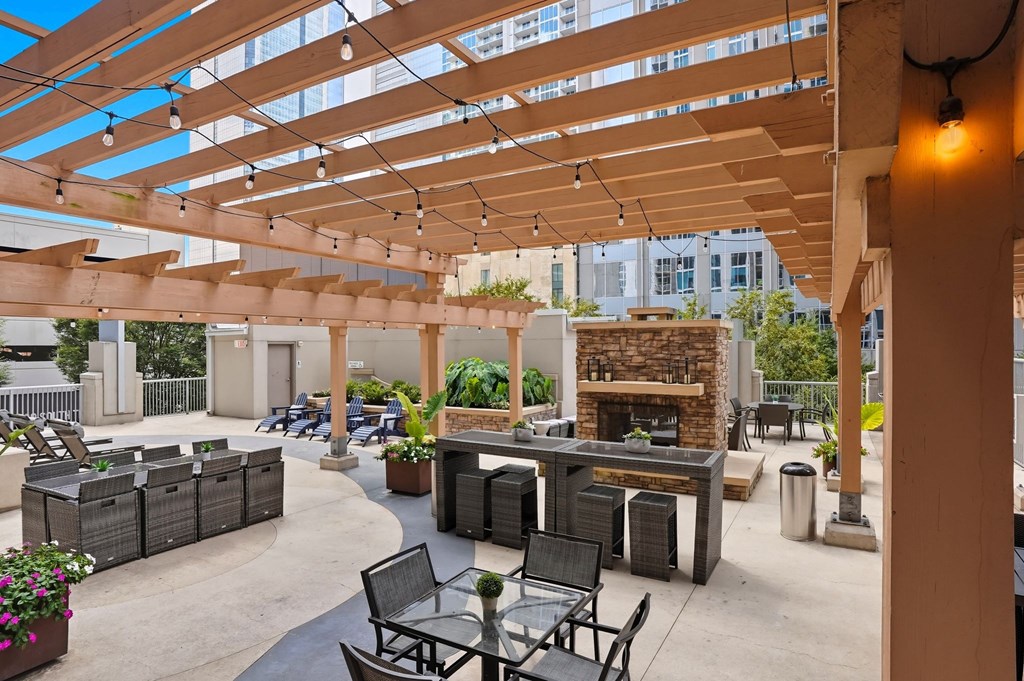 A patio with a fireplace and seating area.