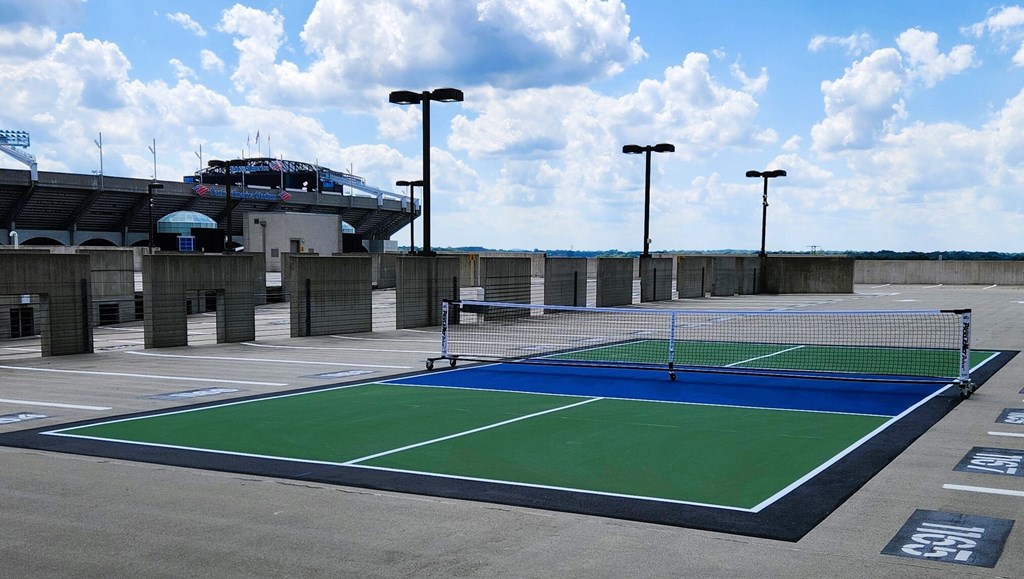 A tennis court is shown with a blue and green surface.