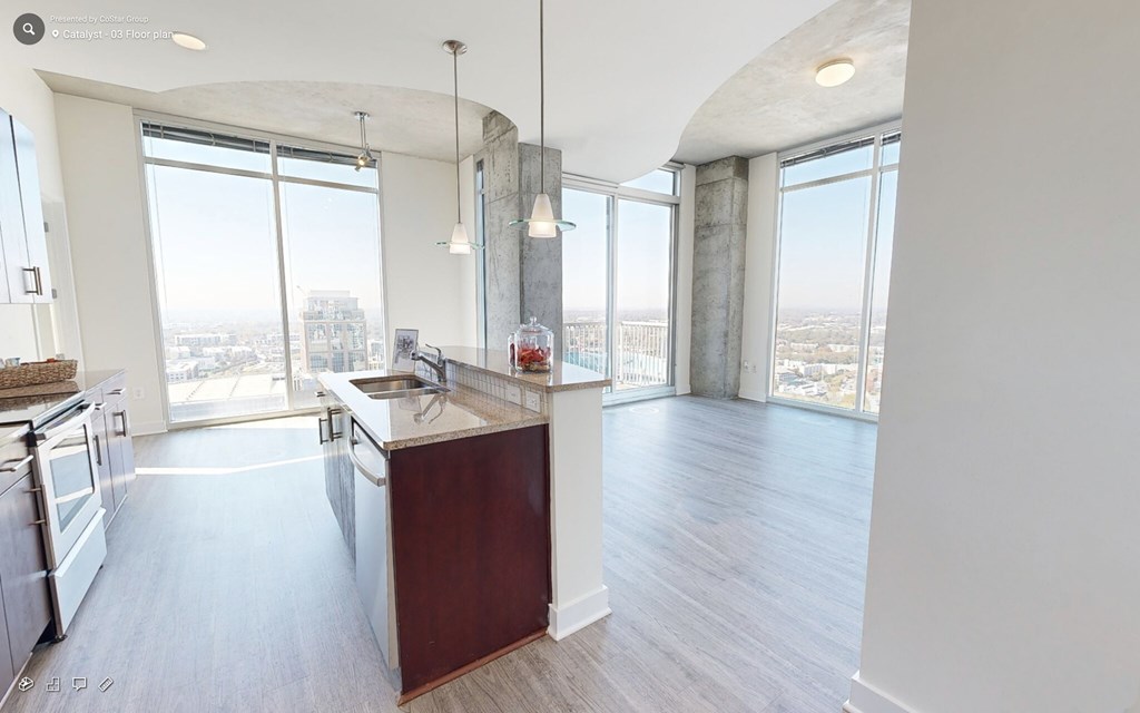 A kitchen with a view of the city.