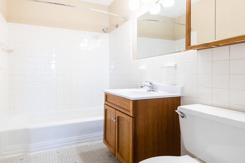 a small bathroom with a toilet sink and bath tub
