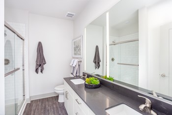 Two sink bathroom with glass shower