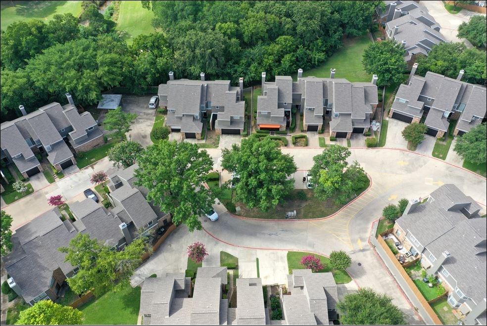 an aerial view of a neighborhood with houses and trees