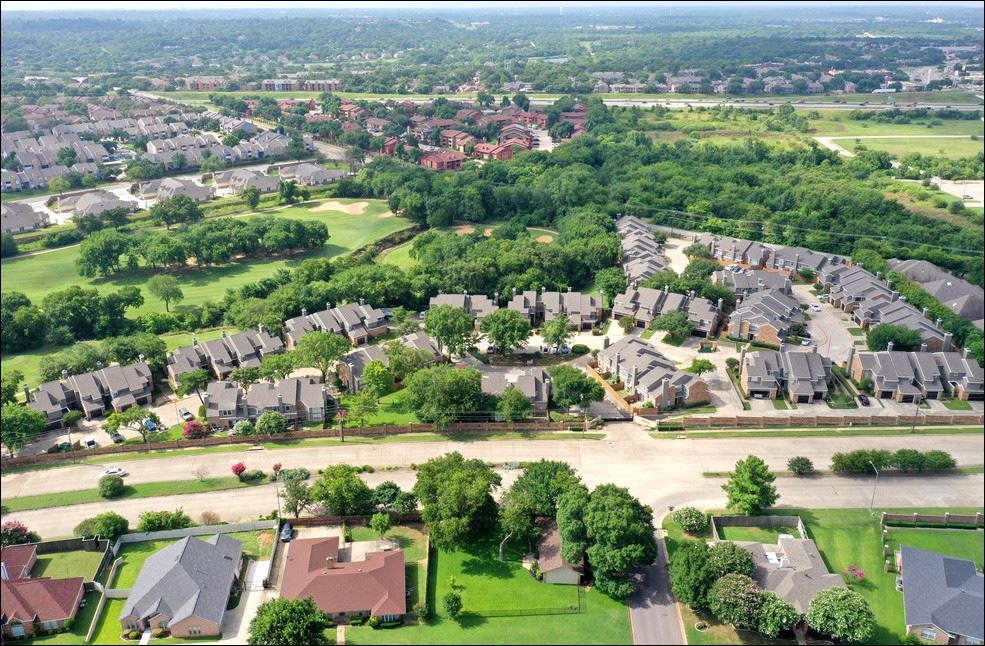 an aerial view of a neighborhood with houses and trees