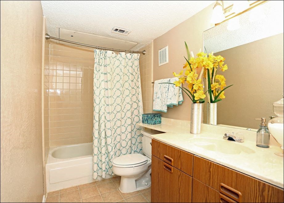 a bathroom with a toilet and a sink and a shower