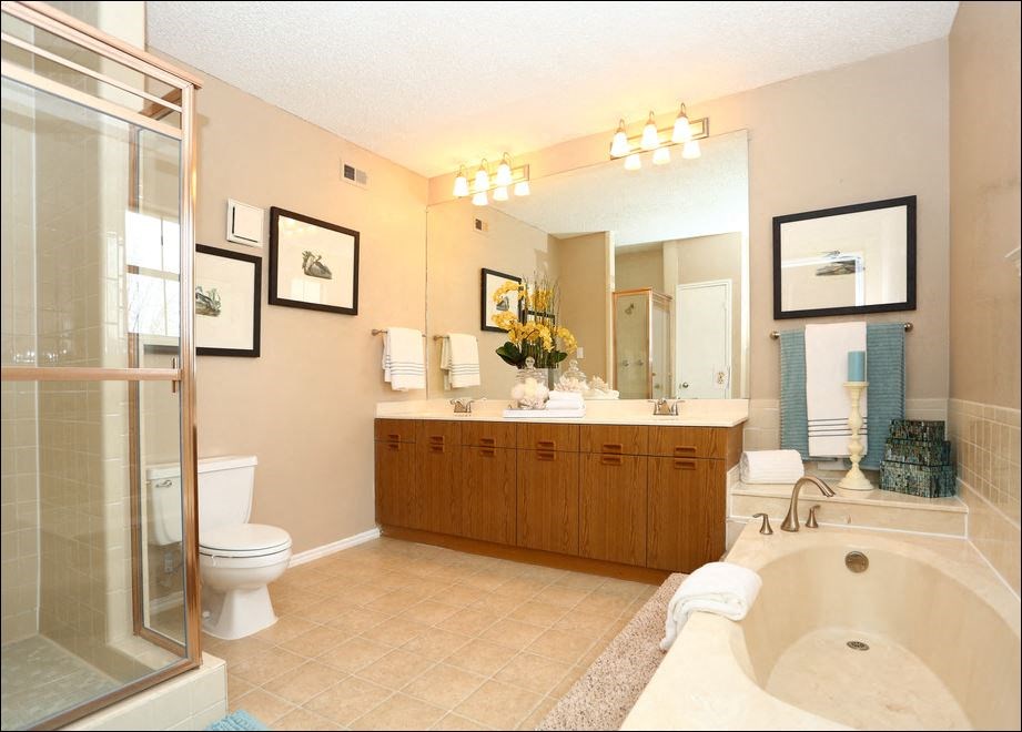 a large bathroom with a tub and a shower and a sink