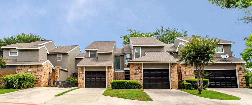 a row of houses with garages in front of them