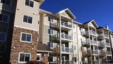 a row of apartment buildings with balconies and stairs