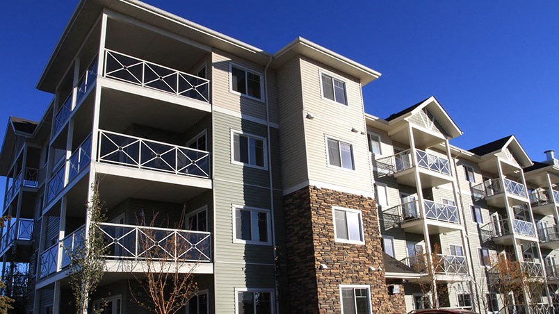 an apartment building with balconies and a blue sky