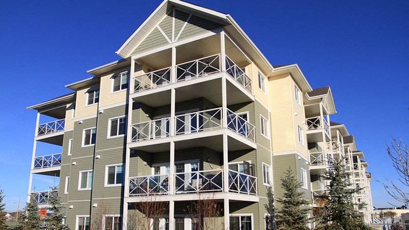a large apartment building with balconies on a sunny day