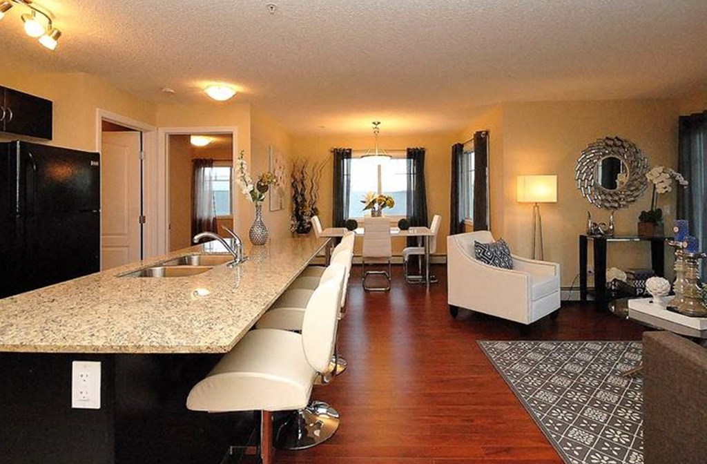 a kitchen and living room with a counter top