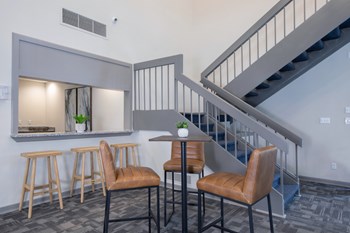 seating bar area and seating by stairs in clubhouse - Photo Gallery 4