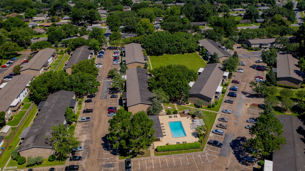 an aerial view of a neighborhood with houses and a swimming pool