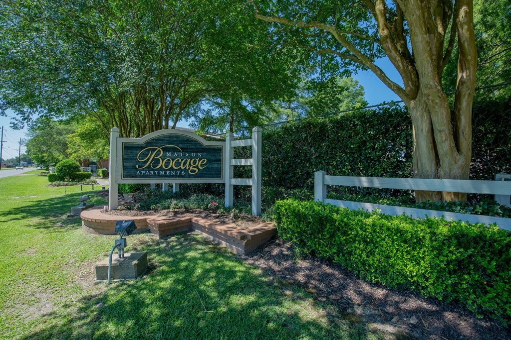 a sign for boogie park in front of a fence and trees