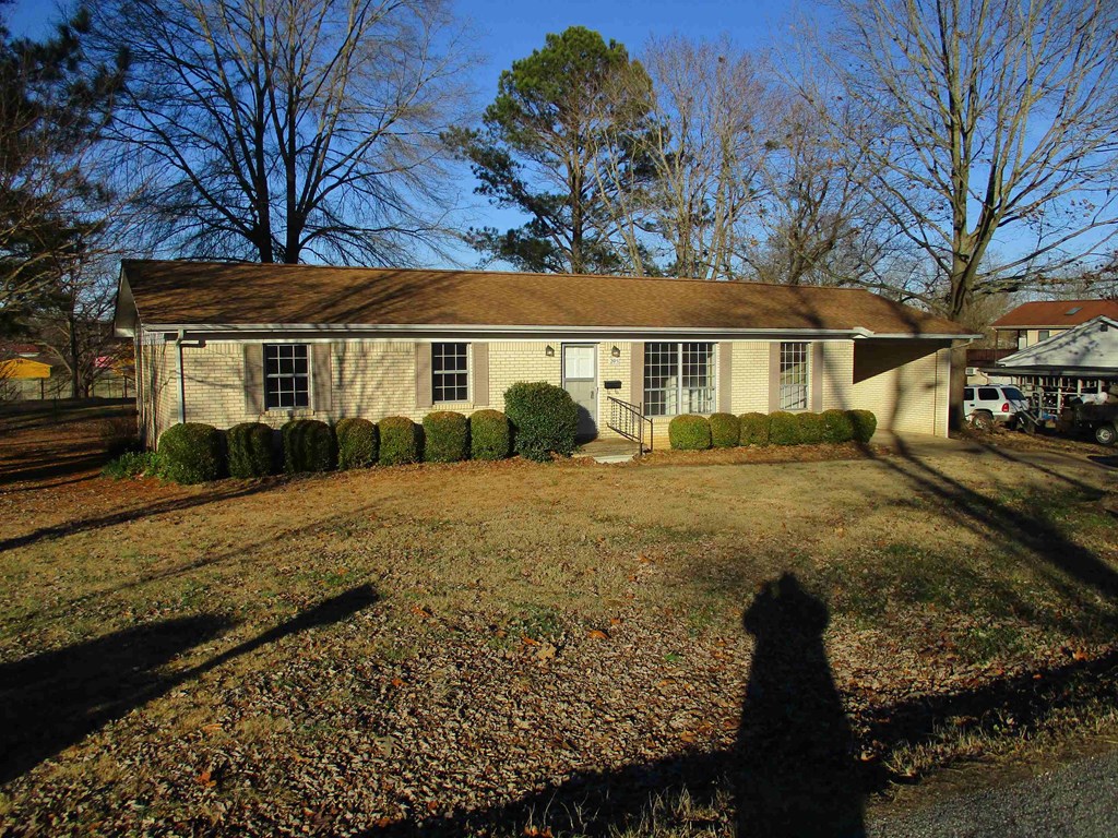 the front of the house with the yard in front of it