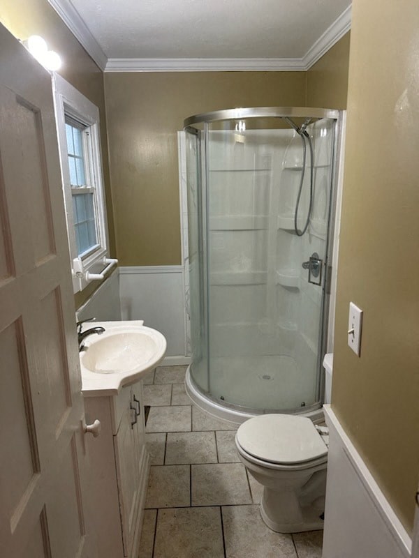 a bathroom with a shower and a sink and a toilet