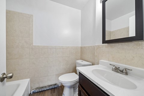 a bathroom with a sink toilet and a mirror