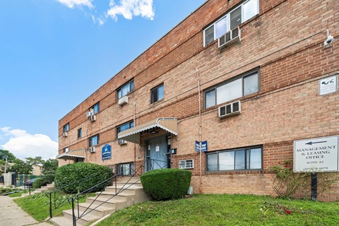 a brick building with a sign for the cancer society
