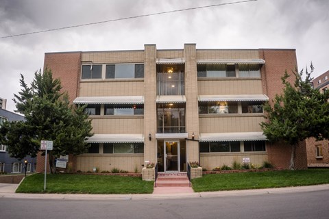 A building with a red brick facade and a white awning.