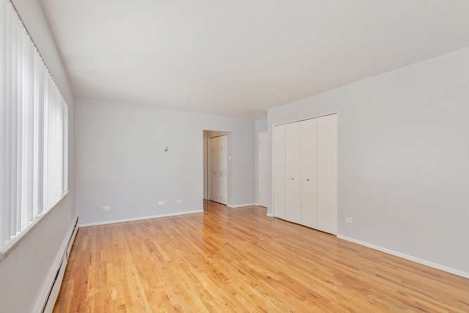 A room with wooden floors and white walls.
