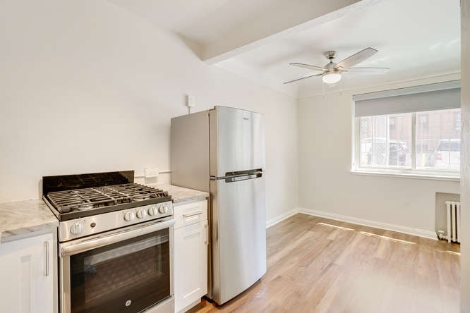 A kitchen with a stove, oven, and refrigerator.