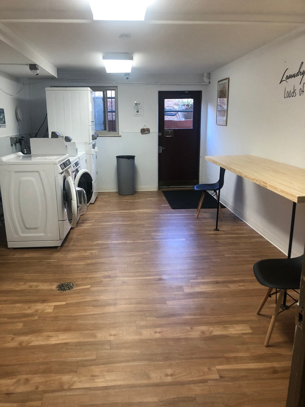 a laundry room with two washing machines and a table with chairs