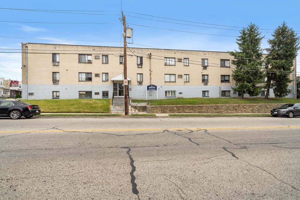 an apartment building on the corner of a street
