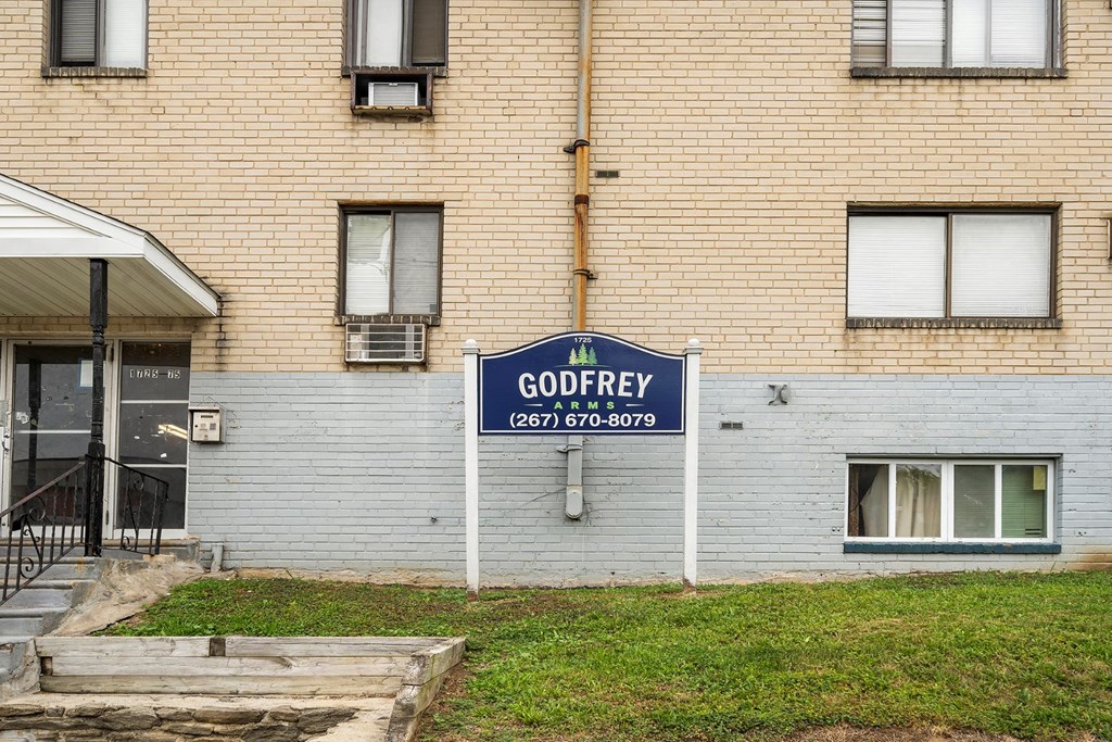 a blue sign in front of a brick building