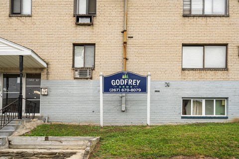 a blue sign in front of a brick building