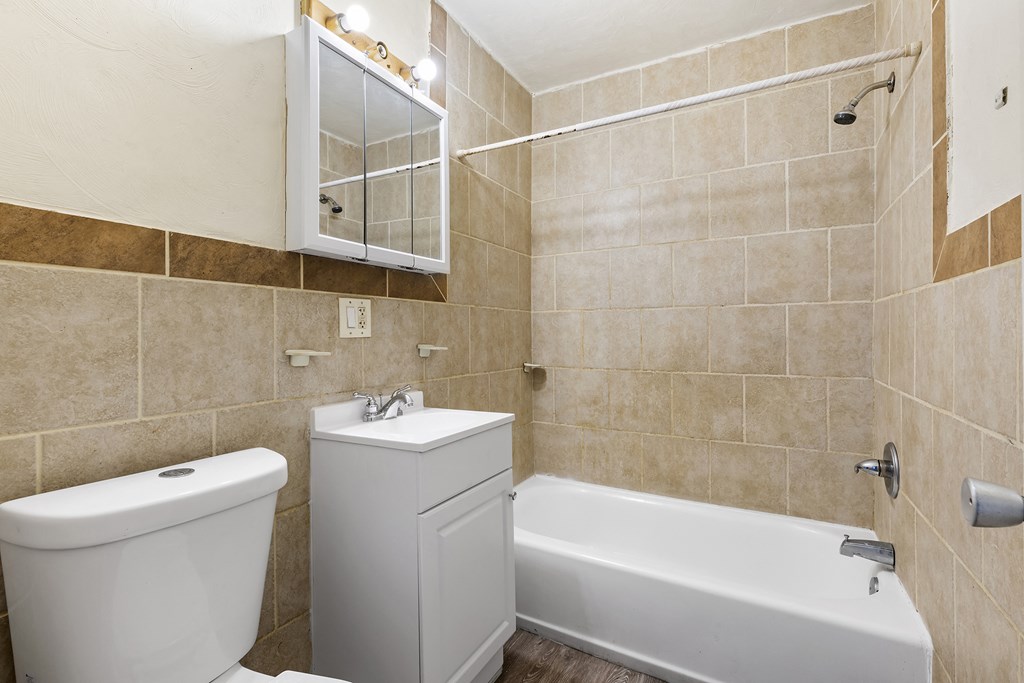 a bathroom with a sink toilet and a bath tub