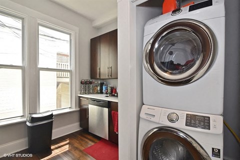 a small laundry room with a washing machine and a washer and dryer
