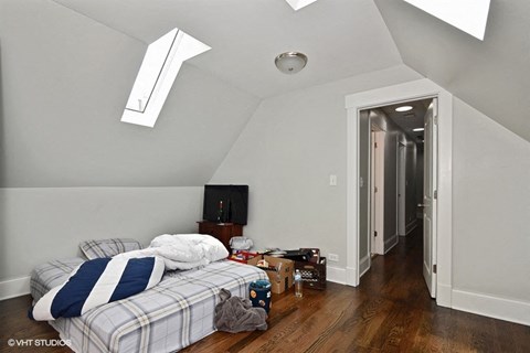 a bedroom with a bed and a tv in a loft