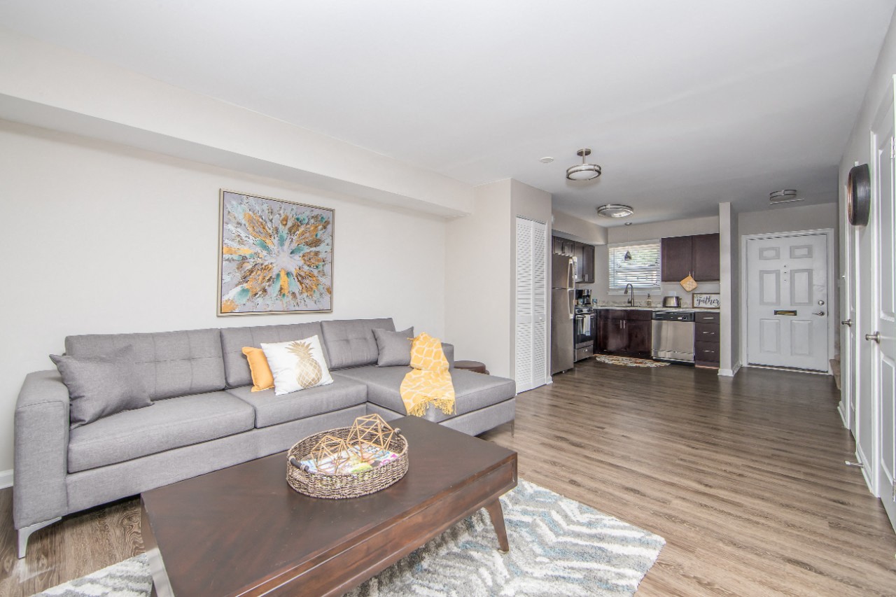 Living room with hardwood floor at Villages at City Center apartments in Newport News VA
